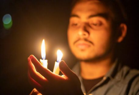 Heat Therapy - man in gray shirt holding lighted candle