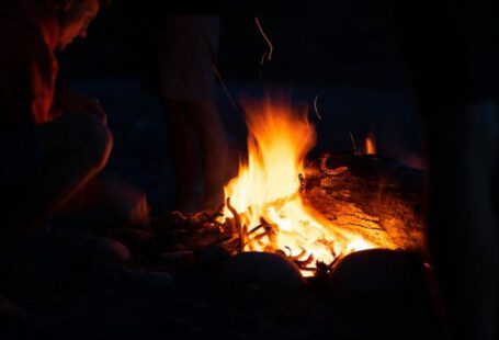 Firecamp - man in black jacket standing near bonfire