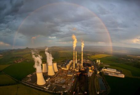 Thermal Power Plant - a large factory with a rainbow in the background